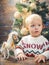 Happy child with christmas gift box. Cheerful cute child opening a Christmas present. Cute little child is decorating