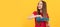 happy child combing long hair on yellow background, haircare. Kid girl hair care, horizontal poster. Banner header with