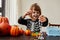 Happy child dressing up with decorations before halloween holiday