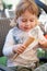 Happy child eating ice cream cone with spoon