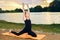 Happy child is engaged in yoga on the river bank