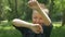 Happy child enjoys dandelion flying with green trees and sunlight in the park