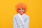 happy child in fancy orange wig hair wear home bathrobe, childhood