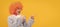 happy child in fancy orange wig hair wear home bathrobe pointing finger on copy space, advertisement. Funny teenager
