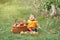 Happy child on farm picking apples in orchard