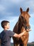 Happy child feeding a hungry and honorable horse