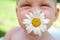 Happy child with a flower chamomile