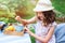 happy child girl drinking tea with lemons in summer garden