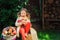 Happy child girl harvesting apples in autumn garden. Seasonal outdoor rural activity