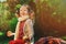 Happy child girl harvesting apples in autumn garden. Seasonal outdoor rural activity