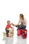 Happy child girl kid standing near little table with big yellow