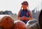 Happy child girl with little pumpkin outdoors