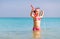 Happy child girl in a mask on the beach