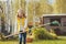 Happy child girl playing little gardener in autumn and picking leaves into basket. Seasonal garden work