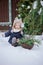 Happy child girl plays in winter snowy garden