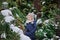 Happy child girl plays in winter snowy garden