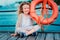 Happy child girl with rescue ring with sea background, safety on the water concept