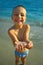 Happy child holding jellyfish in hands