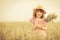 Happy child holding wheat