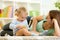 Happy child holds animal toy playing with mom in