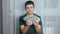 Happy Child Holds a Lot of 100 Dollar Bills in Hands, Clutching them to Chest