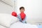 Happy child in hospital room with boxing gloves smiling for his healing on a white background