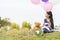 Happy Child hug teddy bear hold air balloon in green park playground. Teddy bear best friend for little kids cute girl. Autism