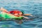 Happy child on an inflatable circle swims on the sea, in the summer resting on the sea. little boy has fun and swims on an