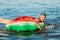 Happy child on an inflatable circle swims on the sea, in the summer resting on the sea. little boy has fun and swims on an