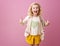 Happy child isolated on pink background showing thumbs up