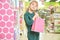 Happy child keeping bag with new doll and looking at camera