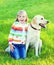 Happy child with labrador retriever dog on grass