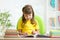 Happy child learning to read in nursery