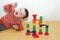 A happy child lies and plays in a maze with a rolling ball. An educational game for a child. Multi-colored toy for the development