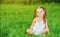 Happy child little girl in white dress lying on grass Summer