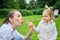 Happy child with mom blows soap bubbles