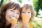 Happy child and mother eating ice cream