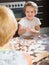 Happy child with mother makin dumplings