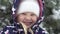 Happy child outdoors in winter. Little girl smiling against the backdrop of snow outdoors