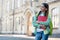 Happy child with pensive look hold books and school bag outdoors, schooling, copy space