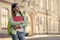 Happy child with pensive look hold books and school bag outdoors, schooling, copy space