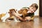 Happy child playing and embracing his puppy indoor. Teen boy with his puppy. Best friend and pet. Lovely dog. Kid and