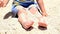 Happy child playing with sand at the beach in summer. Kids playing in the sands. This activity is good for sensory