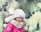 Happy child playing snowballs outdoor.