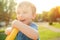 Happy child playing in the sun. Little boy relax outdoors. Funny child have great time in summer. Happy and health childhood.