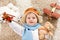 Happy child playing with toy airplane. Kid boy lying on fluffy carpet