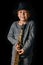 Happy child plays saxophone in studio