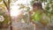 Happy child plays with soap bubbles in park in sunlight on nature