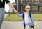 Happy child schoolboy smiles and holds his mother\'s hand on the way to school on the first sunny day of class