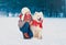 Happy child sitting with his white Samoyed dog in winter day